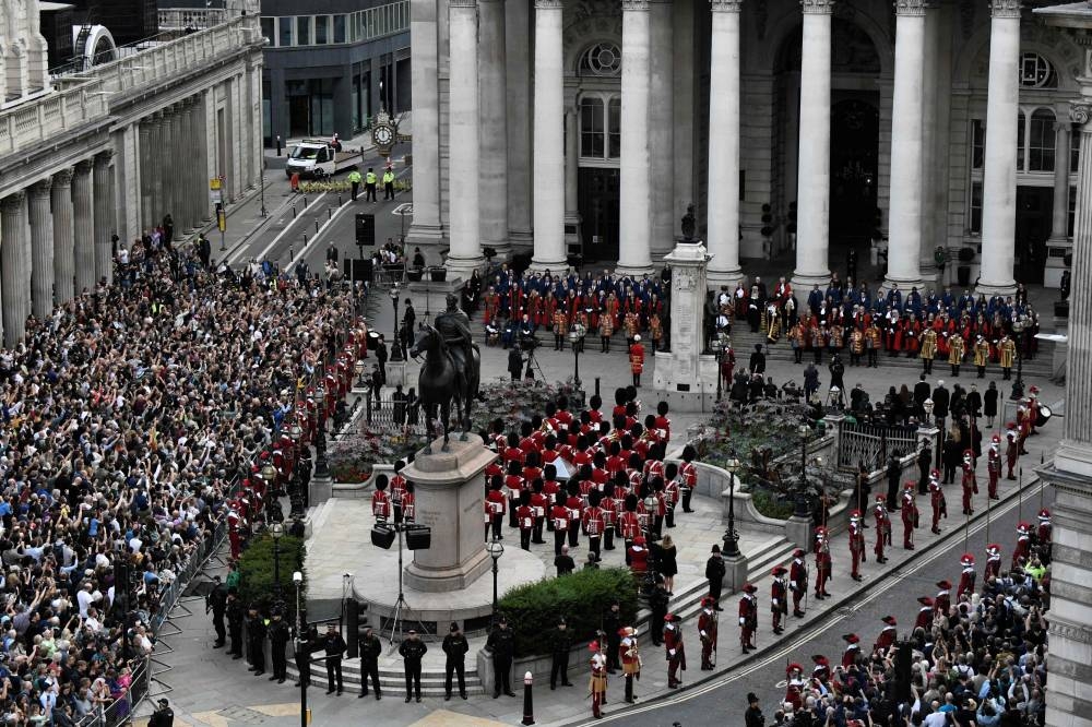 Members of the public and members of the military in ceremonial uniform attend the second Proclamation of Britain’s new King, King Charles III, at the Royal Exchange, in the City of London, on September 10, 2022. ― AFP pic