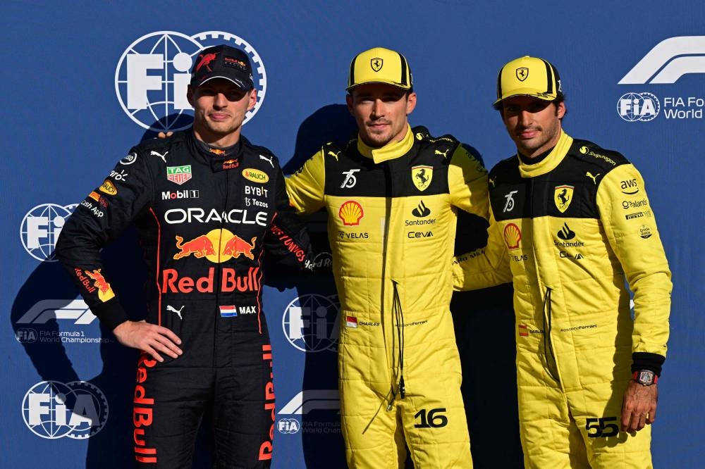 (Left to Right) Red Bull Racing’s  Dutch driver Max Verstappen, Ferrari’s Monegasque driver Charles Leclerc and Ferrari’s Spanish driver Carlos Sainz Jr pose after the qualifying session ahead of the Italian Formula One Grand Prix at the Autodromo Nazionale circuit in Monza on September 10, 2022. ― AFP pic