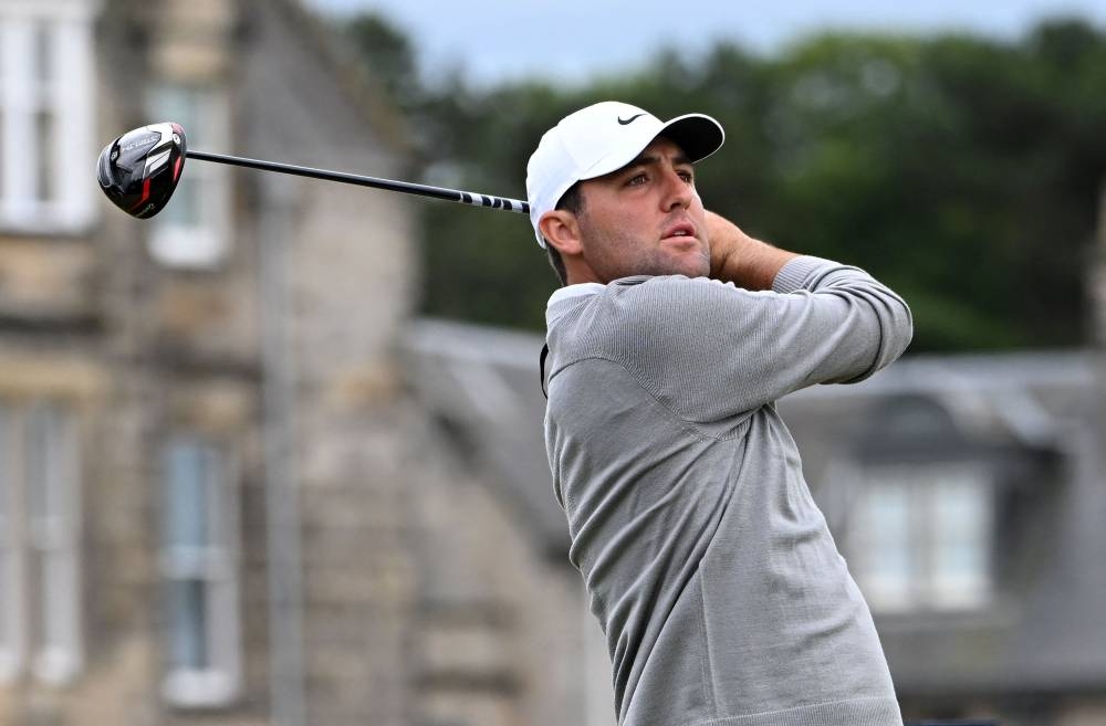 In this file photo taken on July 14, 2022, US golfer Scottie Scheffler watches his drive from the 2nd tee during his opening round on the first day of The 150th British Open Golf Championship on The Old Course at St Andrews in Scotland. — AFP pic
