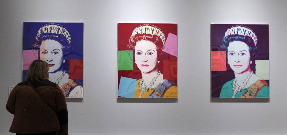 In this file photo taken on January 15, 2012 a women views silkscreen prints of Queen Elizabeth II by artist Andy Warhol during 'The Queen: Art and Image' exhibition at the Ulster Museum in Belfast, Northern Ireland. — AFP pic