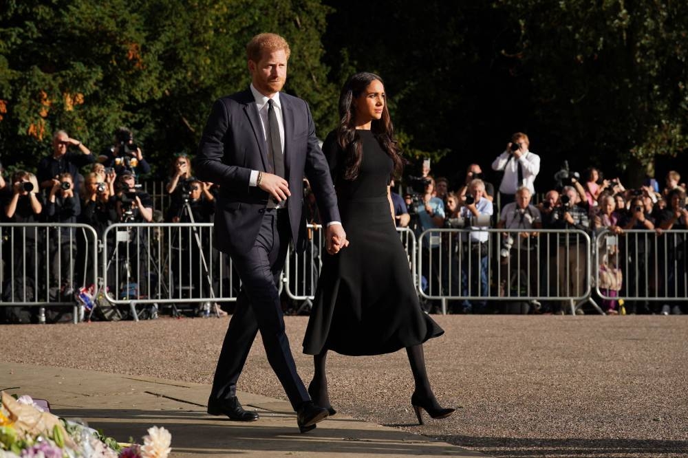 Britain's Prince Harry, Duke of Sussex and Meghan, Duchess of Sussex arrive to look at floral tributes on the Long walk at Windsor Castle on September 10, 2022, two days after the death of Britain's Queen Elizabeth II at the age of 96. — AFP pic