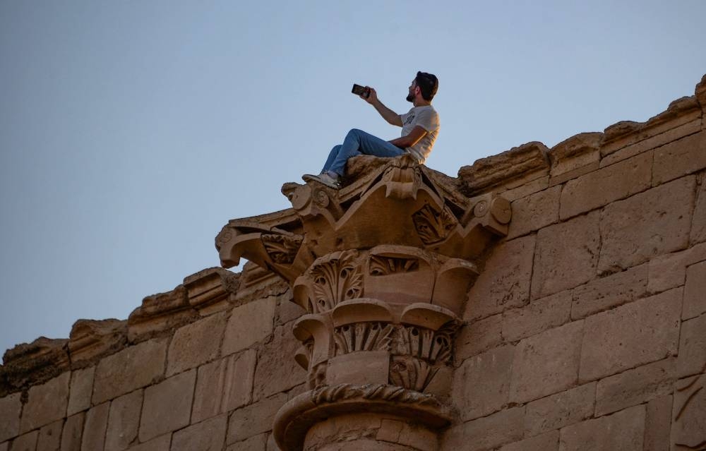 A tourist visits the ancient city of Hatra in northern Iraq on September 10, 2022, as local authority initiatives seek to encourage tourism and turn the page on the years of violence by the Islamic State IS group. — AFP pic