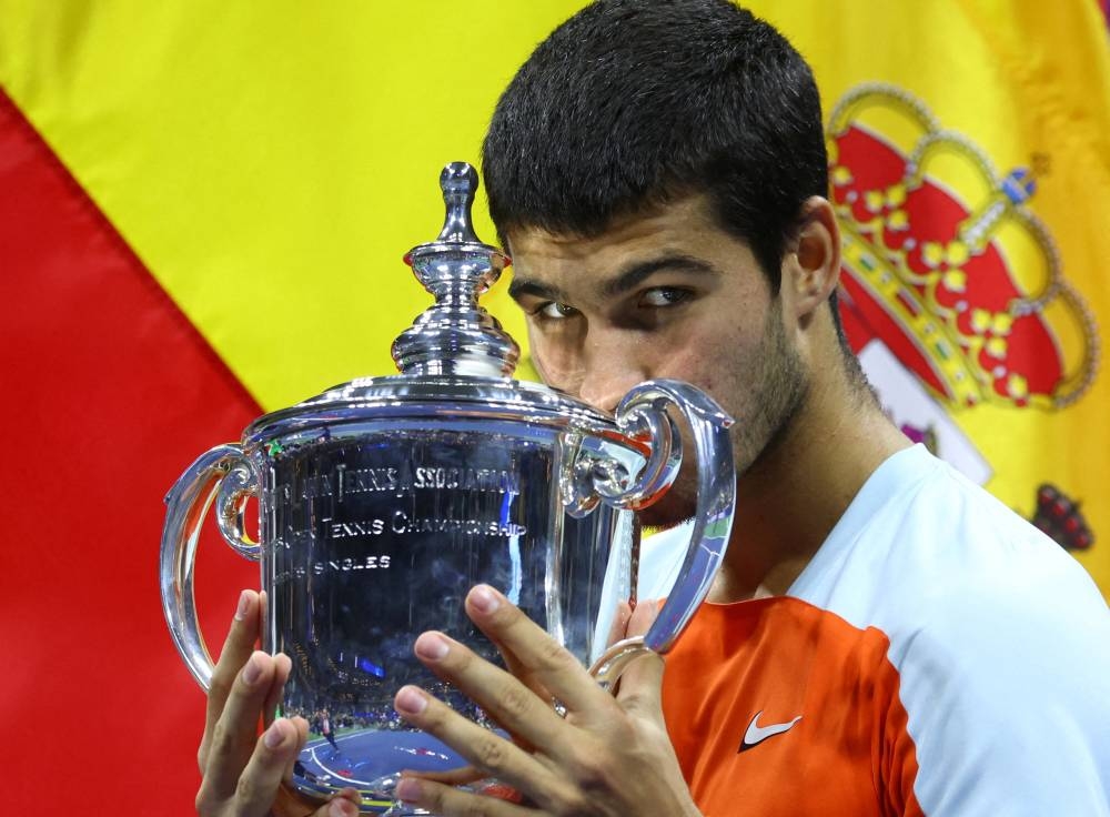 Carlos Alcaraz celebrates with the trophy after winning the US Open in New York September 11, 2022. — Reuters pic