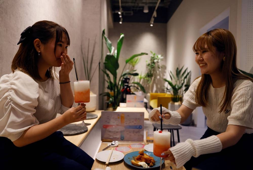 Customers drink cocktails made with no alcohol during a photo opportunity at Sumadori Bar in Tokyo, Japan September 2, 2022. — Reuters pic