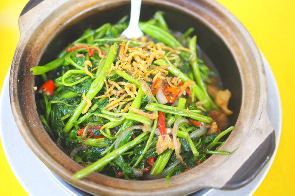 The claypot 'kangkung' marries essential greens with sinful crispy lard fritters and anchovies for a delicious dish.