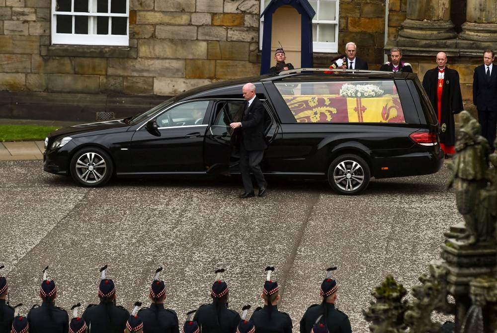 The hearse carrying the coffin of Queen Elizabeth II arrives at Palace of Holyroodhouse, where she will lie overnight and then be moved to St Giles Cathedral, in Edinburgh, Scotland September 11, 2022. — Lisa Ferguson/Pool pic via Reuters