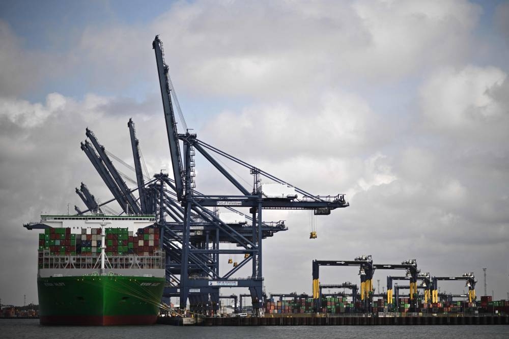 Piles of containers are pictured on the deck of the Ever Alot container ship docked at the empty UK's largest freight port, in Felixstowe, on August 22, 2022, during a dock workers eight-day strike over pay. — AFP pic