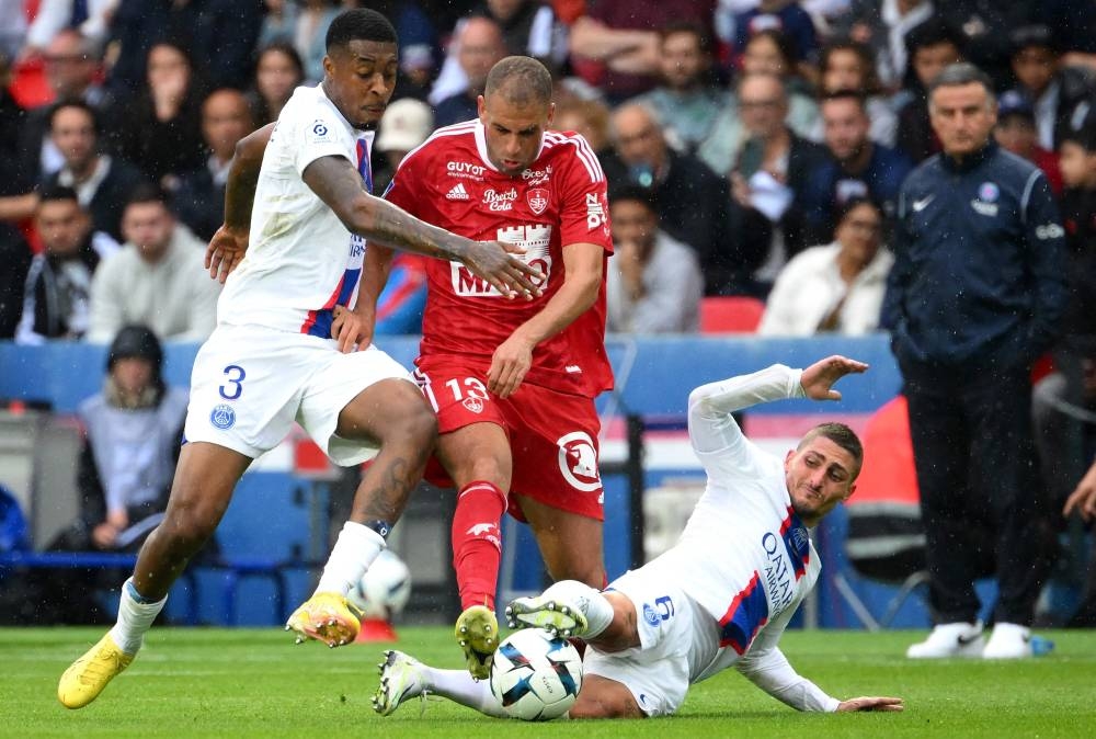 Paris Saint-Germain defender Presnel Kimpembe (left), Brest forward Islam Slimani and midfielder Marco Verratti (right) fight for the ball at the Parc des Princes Stadium in Paris, September 10, 2022. — AFP pic 