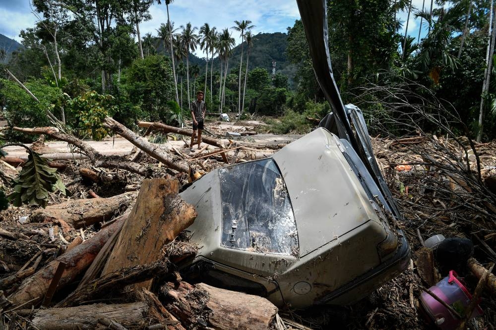 File picture of a car destroyed by river currents in Kampung Iboi after being hit by floods July 5, during a survey in Baling, Kedah, July 6, 2022. — Bernama pic