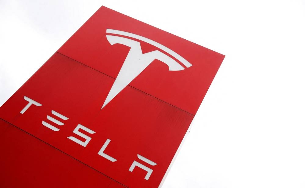 The logo of car manufacturer Tesla is seen at a dealership in London May 14, 2021. — Reuters pic 