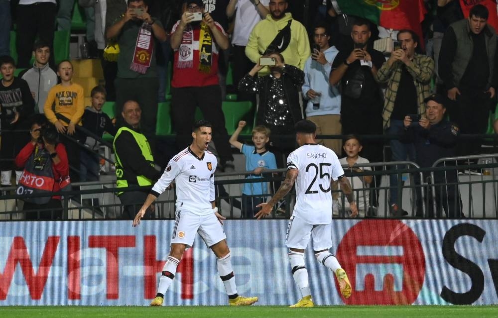Manchester United's Portuguese striker Cristiano Ronaldo celebrates with teammates after scoring the 0-2 from the penalty spot during the UEFA Europa League group E football match between Sheriff and Manchester United at Zimbru stadium in Chisinau on September 15, 2022. — AFP pic