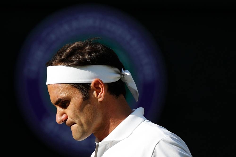 In this file photo taken on July 12, 2019 Switzerland's Roger Federer reacts after a point against Spain's Rafael Nadal during their men's singles semi-final match on day 11 of the 2019 Wimbledon Championships at The All England Lawn Tennis Club in Wimbledon. — Adrian Dennis/Pool/AFP pic