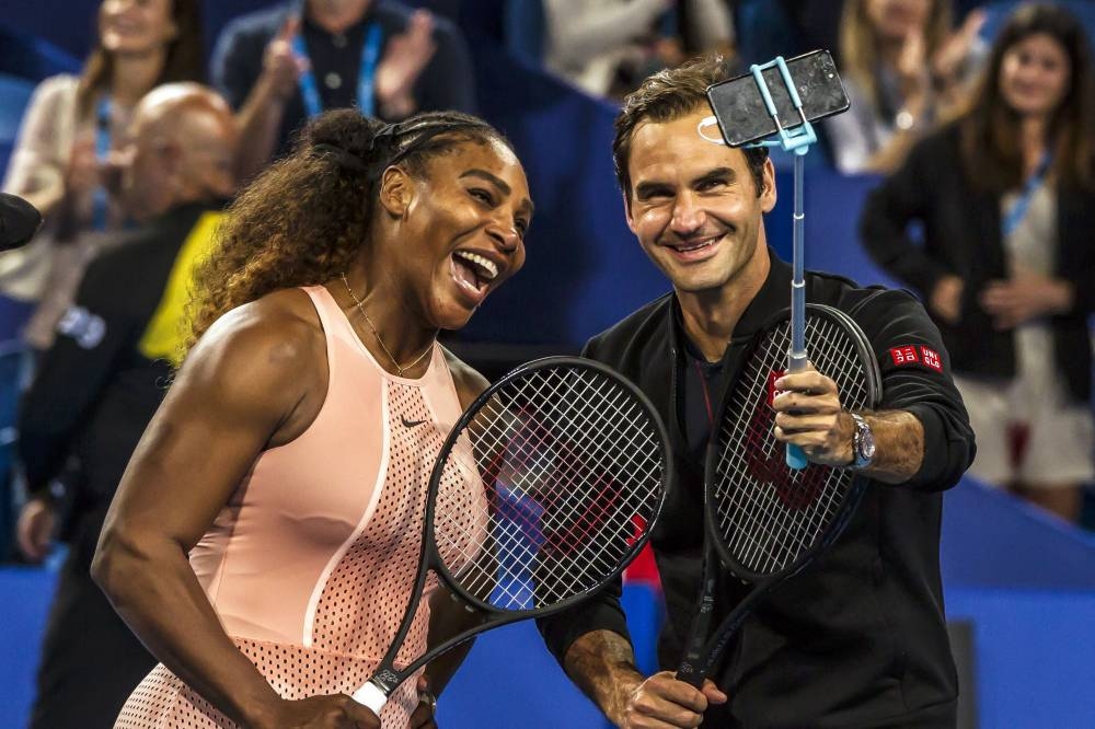 In this file photo taken on January 1, 2019 Serena Williams of the US (left) and Roger Federer of Switzerland (right) take a selfie following their mixed doubles match on day four of the Hopman Cup tennis tournament in Perth. — AFP pic