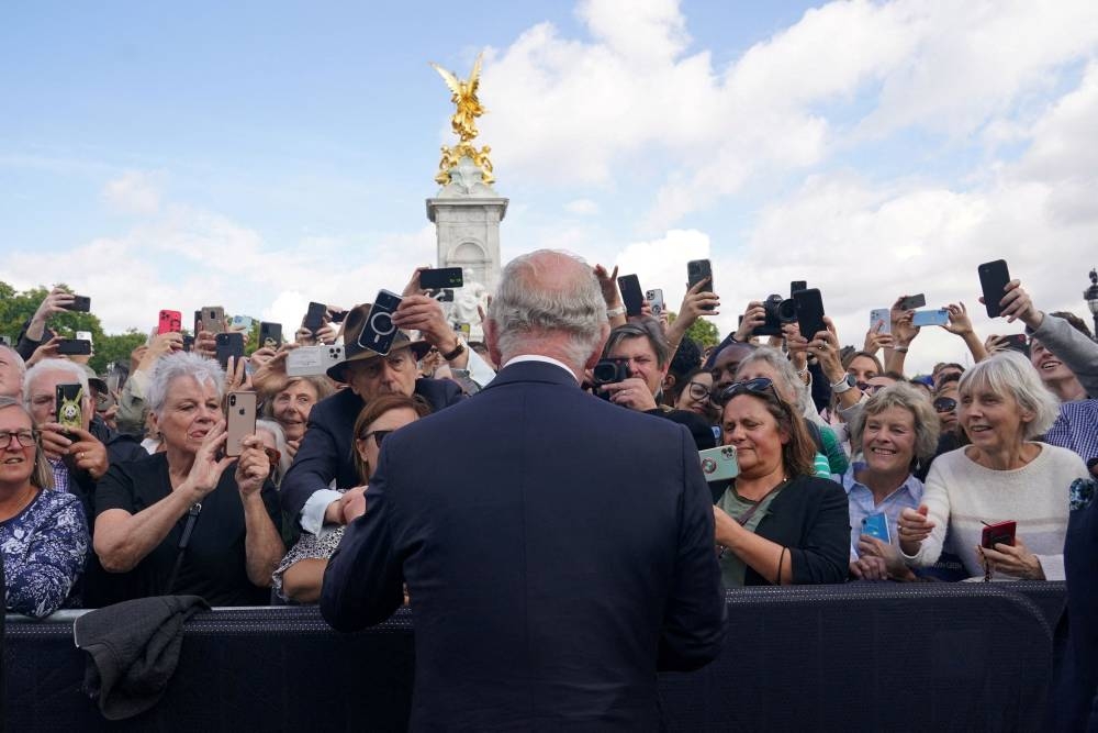 King Charles III is greeted by well-wishers during a walkabout to view tributes left outside Buckingham Palace, London, following the death of Queen Elizabeth II on Thursday. Picture date: Friday September 9, 2022. — Reuters pic