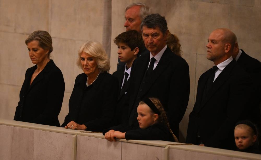 Britain’s Sophie, Countess of Wessex, Britain’s Camilla, Queen Consort and Vice Admiral Timothy Laurence attend a vigil around the coffin of Queen Elizabeth II, draped in the Royal Standard with the Imperial State Crown and the Sovereign’s orb and sceptre, lying in state on the catafalque in Westminster Hall, at the Palace of Westminster in London on September 16, 2022, ahead of her funeral on Monday. — AFP pic