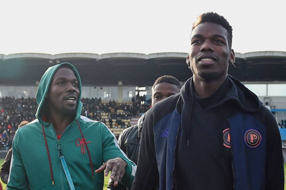 Paul Pogba and his brother Mathias Pogba (left) walk on the pitch prior to a football match between All Star France and Guinea at the Vallee du Cher Stadium in Tours, central France December 29, 2019. — AFP pic 
