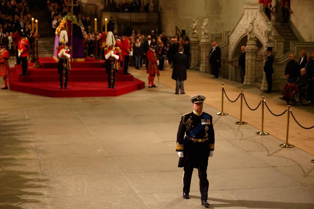 Britain's Prince Andrew, Duke of York leaves after attending a vigil around the coffin of Queen Elizabeth II, draped in the Royal Standard with the Imperial State Crown and the Sovereign's orb and sceptre, lying in state on the catafalque in Westminster Hall, at the Palace of Westminster in London on September 16, 2022, ahead of her funeral tomorrow. — Hannah McKay/Pool/AFP pic