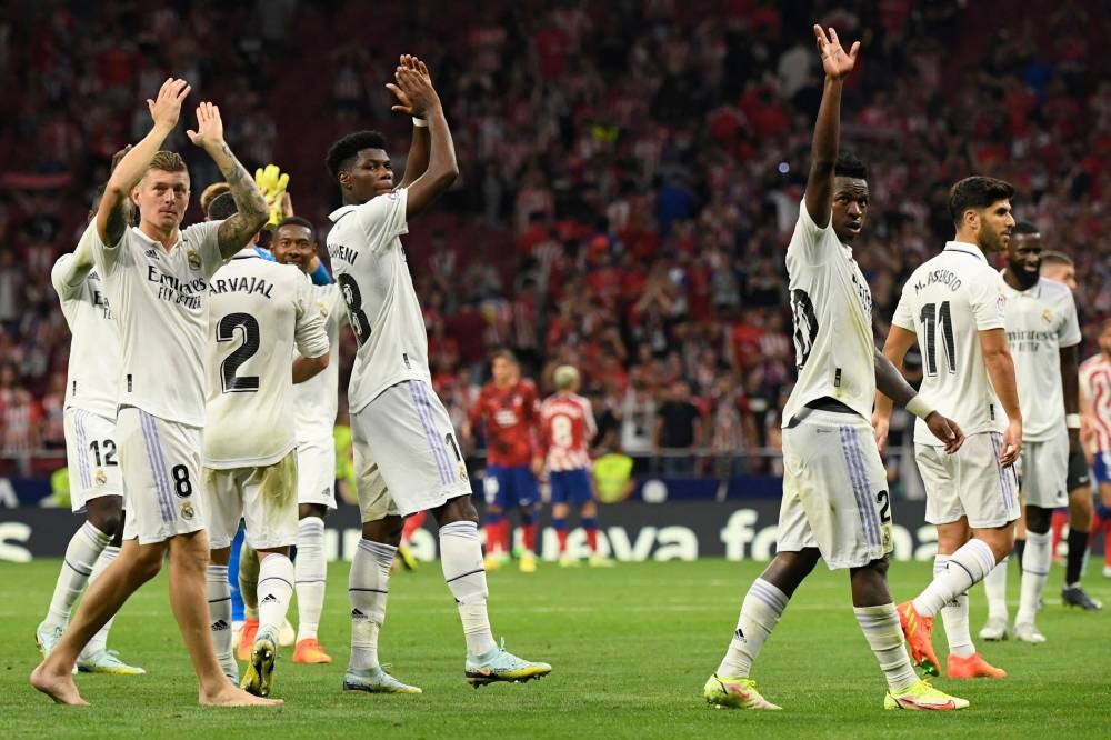 Real Madrid players celebrate victory at the end of the Spanish League football match between Club Atletico de Madrid and Real Madrid CF at the Wanda Metropolitano stadium in Madrid on September 18, 2022. — AFP pic