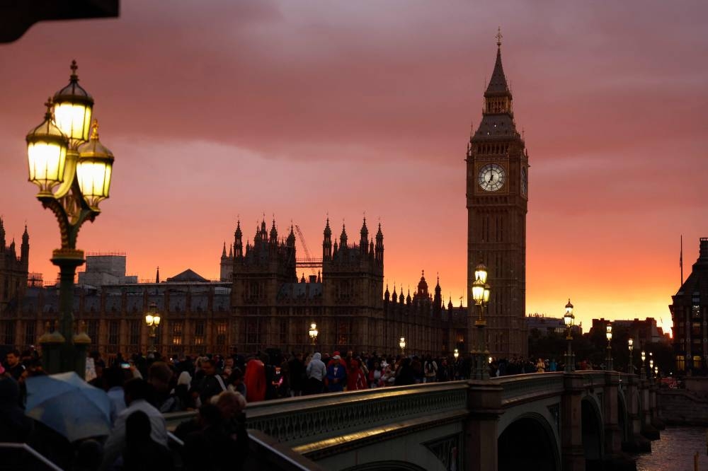 Members of the public observe a national moment of reflection to show their respects to the late Queen Elizabeth II, on Westminster Bridge in London on September 18, 2022, ahead of her State Funeral on Monday. — AFP pic 