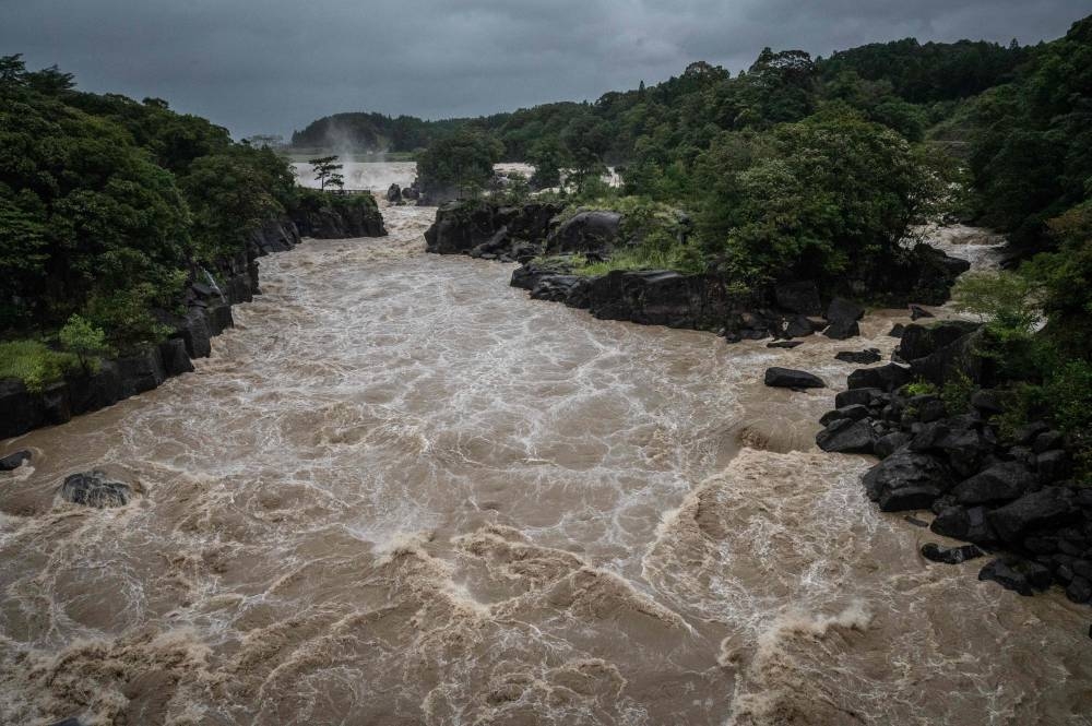 Raging waters flow along the Sendai River in the wake of Typhoon Nanmadol in Isa, Kagoshima prefecture on September 19, 2022. — AFP pic
