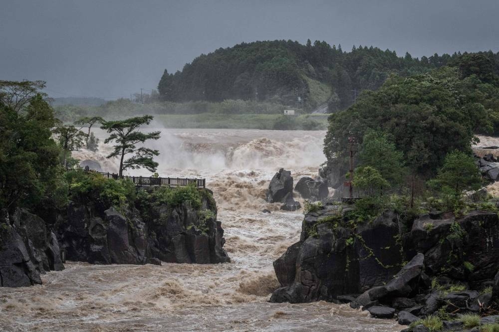 Raging waters flow along the Sendai River in the wake of Typhoon Nanmadol in Isa, Kagoshima prefecture on September 19, 2022.  — AFP pic