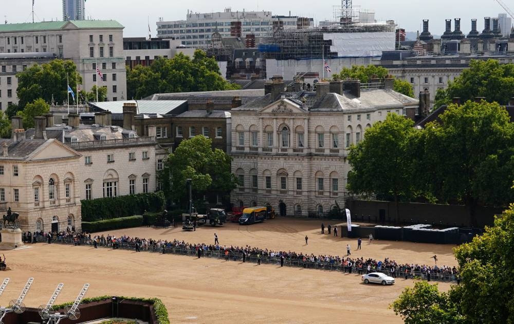 Crowds gather on Horse Guards Parade in central London on September 14, 2022, ahead of the ceremonial procession of the coffin of Queen Elizabeth II, from Buckingham Palace to Westminster Hall. — Victoria Jones/Pool/AFP pic