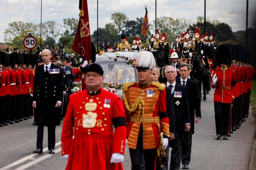 The Procession following the coffin of Queen Elizabeth II, aboard the State Hearse, arrives at The Long Walk in Windsor on September 19, 2022, to make its final journey to Windsor Castle after the State Funeral Service of Britain's Queen Elizabeth II. — Carlos Jasso/Pool/AFP pic
