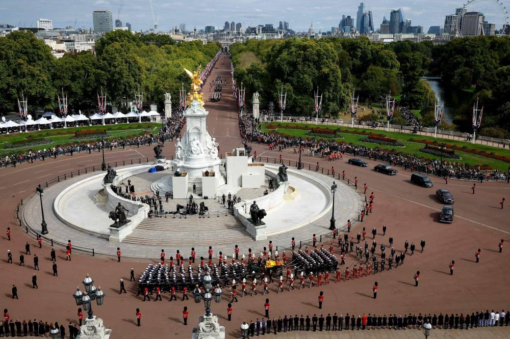 The Queen's funeral cortege borne on the State Gun Carriage of the Royal Navy travels along The Mall and around the Queen Victoria Memorial during the State Funeral of Queen Elizabeth II in London on September 19, 2022. — Chip Somodevilla/Pool/AFP pic