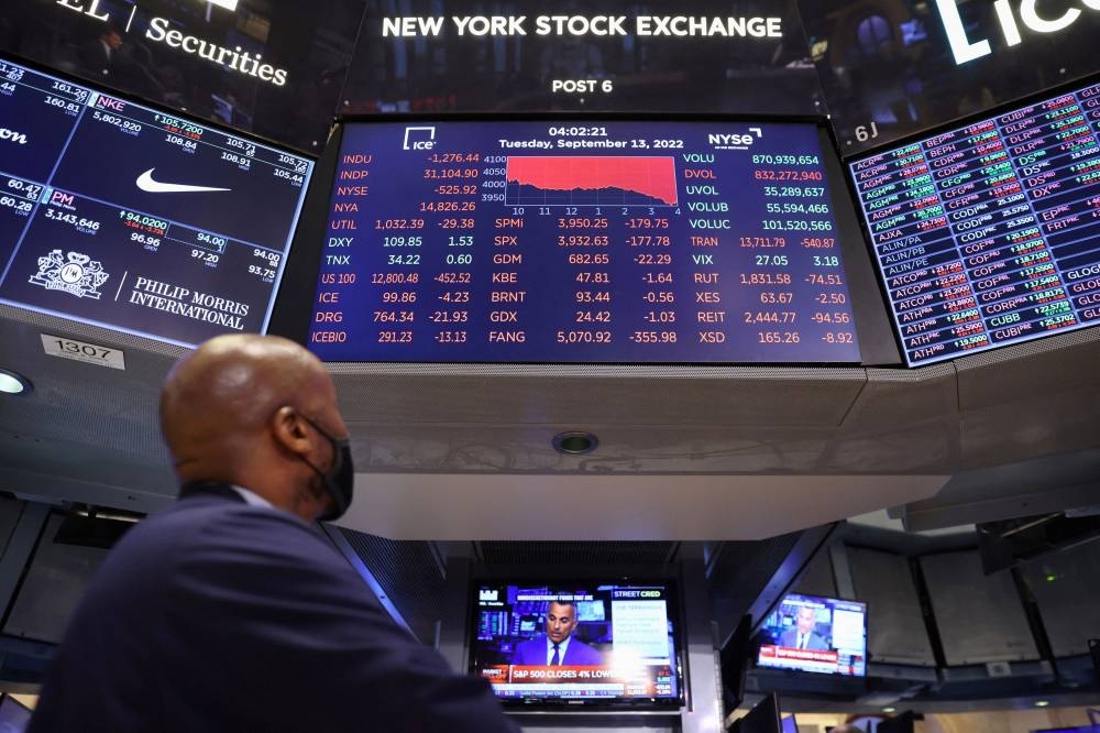 A trader looks at a screen showing the Dow Jones Industrial Average on the trading floor at the New York Stock Exchange in Manhattan, New York City September 13, 2022. — Reuters pic