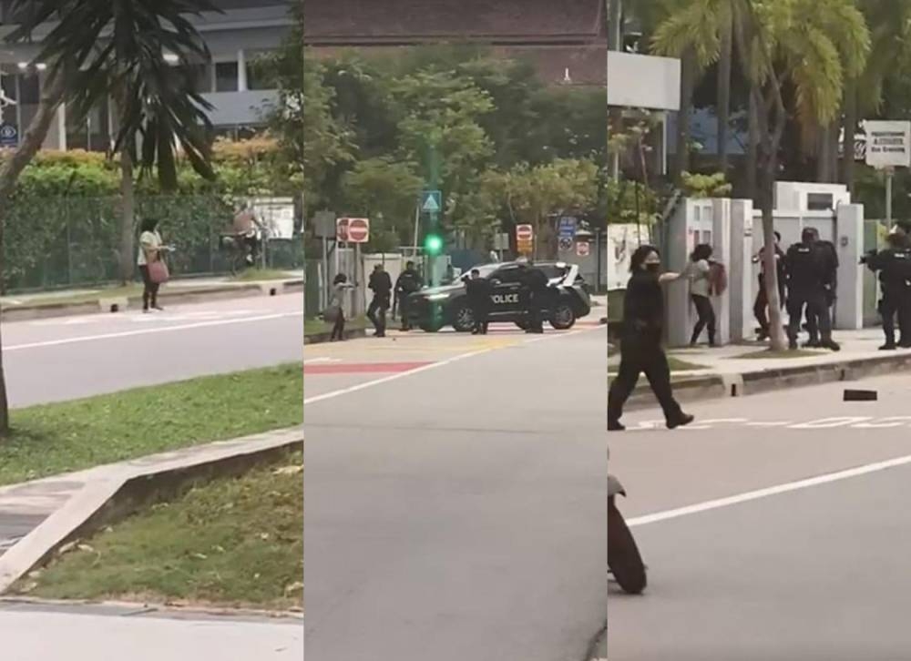 Videos posted on social media show a woman, dressed in a green top, screaming and shouting as she paces about on the road, stopping the flow of traffic outside St Hilda’s Secondary School. ― Picture via social media