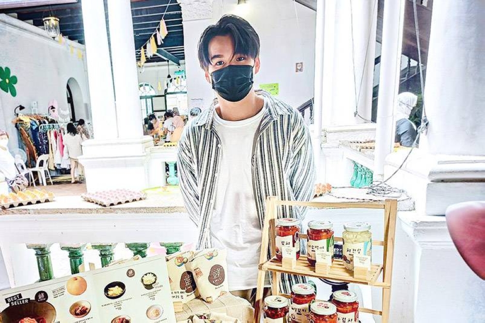 Hyo Kimchi founder Chai Kai Wen at a weekend bazaar with jars of his kimchi.