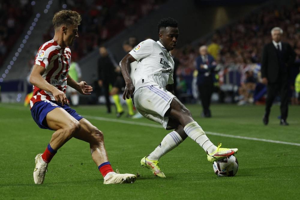 Real Madrid’s Vinicius Junior in action with Atletico de Madrid’s Llorente at Metropolitano, Madrid, Spain, September 18, 2022. — Reuters pic 