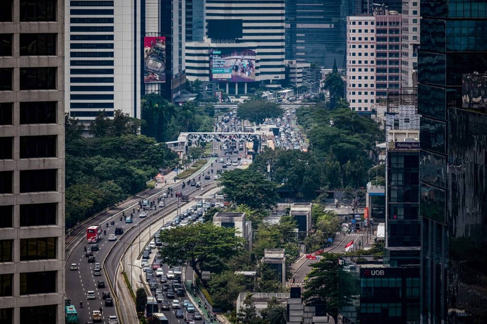 Motorists commute during the morning traffic rush in Jakarta on September 20, 2022. — AFP pic