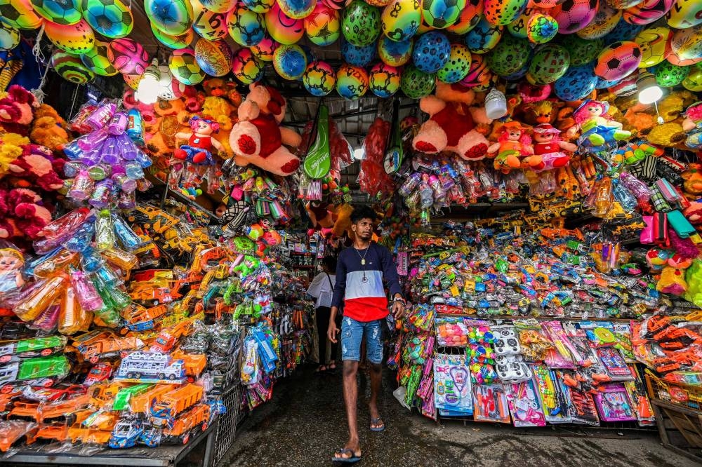 A vendor waits for customers at a toy shop in Colombo on September 20, 2022. — AFP pic