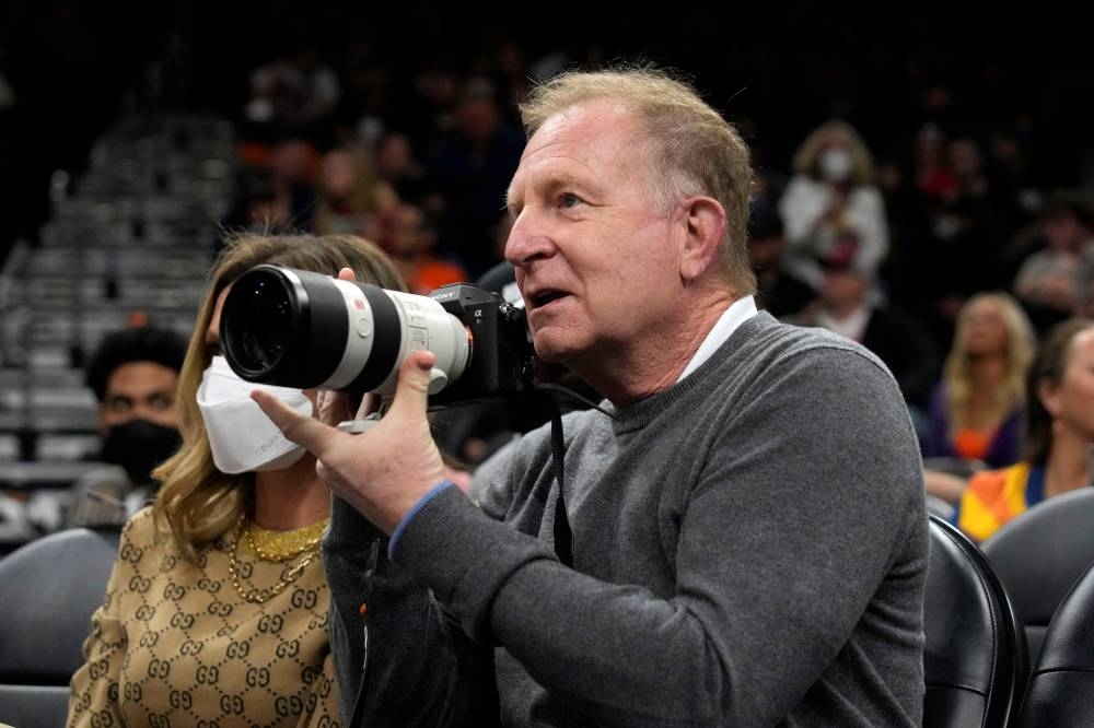 Phoenix Suns owner Robert Sarver takes pictures during a game against the Houston Rockets at Footprint Centre in Phoenix February 16, 2022. — Reuters pic
