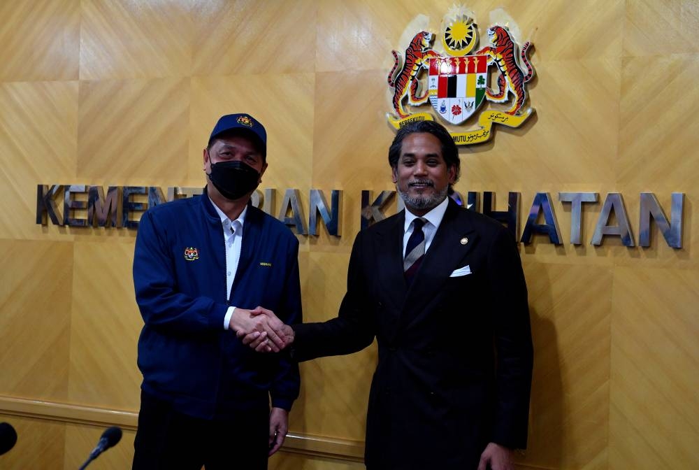Tan Sri Dr Noor Hisham Abdullah (left) and Health Minister Khairy Jamaluddin pose for the cameras at the Ministry of Health, Putrajaya September 22, 2022. — Bernama pic