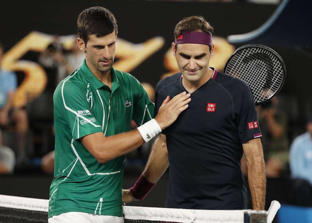 Novak Djokovic pats Roger Federer after their semi-final at the Australian Open in Melbourne January 30, 2020. — Reuters pic