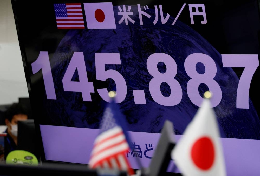 A monitor displaying the Japanese yen exchange rate against the U.S. dollar is pictured at a dealing room of the foreign exchange trading company Gaitame.com in Tokyo, Japan September 22, 2022. — Reuters pic