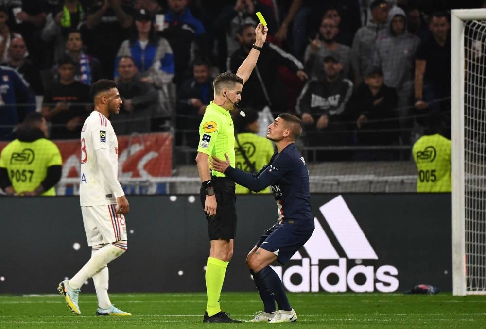 Paris Saint-Germain’s Italian midfielder Marco Verratti receives a yellow card during the match between Olympique Lyonnais and Paris Saint-Germain at The Groupama Stadium in Decines-Charpieu, central-eastern France, September 18, 2022. — AFP pic 