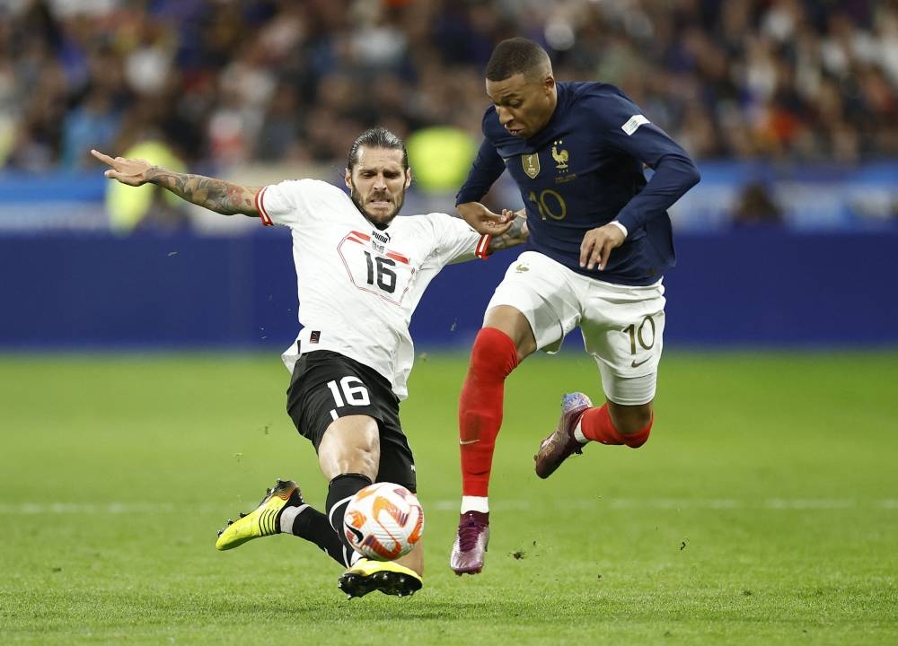 France's Kylian Mbappe in action with Austria's Christopher Trimmel at Stade de France, Saint-Denis September 22, 2022. — Reuters pic
