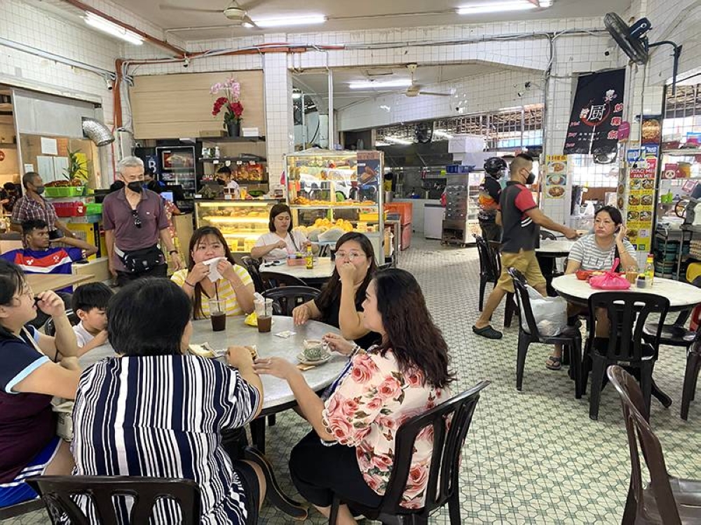 The busy coffeeshop spans two lots, one which is air conditioned for more comfortable dining.