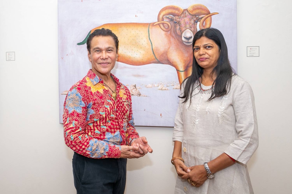 (From left) Ramli and Helen pose for a photograph with one of the paintings in ‘Guardian Spirits’. Ramli said he was keen on bringing Helen's work to Malaysia, as it highlighted the beauty of Odisha traditions while strengthening the cultural links between Malaysia and India. — Picture by Devan Manuel