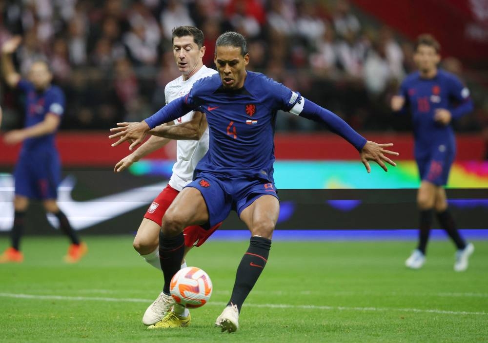 Netherlands’ Virgil van Dijk in action with Poland’s Robert Lewandowski during the Uefa Nations League Group D match at PGE Narodowy, Warsaw, Poland, September 22, 2022. — Reuters pic 