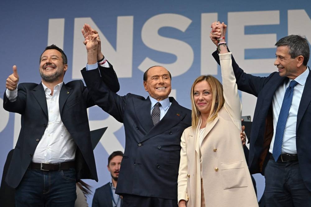 (From left) Lega leader Matteo Salvini, Forza Italia leader Silvio Berlusconi and Brothers of Italy leader Giorgia Meloni stand on stage on September 22, 2022 during a joint rally of Italy's right-wing parties Brothers of Italy (Fratelli d'Italia, FdI), the League (Lega) and Forza Italia at Piazza del Popolo in Rome, ahead of the September 25 general election. — AFP pic
