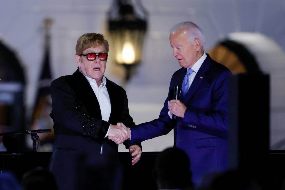 British rocker Elton John reacts to being awarded the National Humanities Medal by US President Joe Biden at the White House in Washington September 23, 2022. — Reuters pic