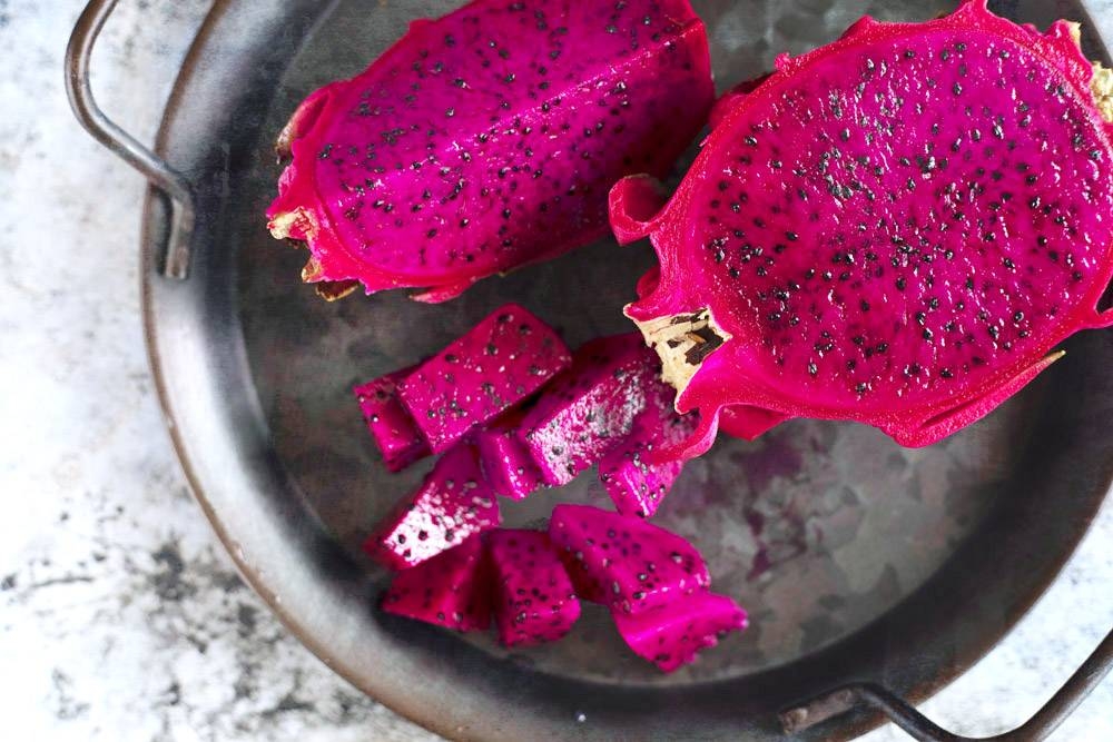Cut the red dragon fruit into half, peel back the skin then slice into cubes.