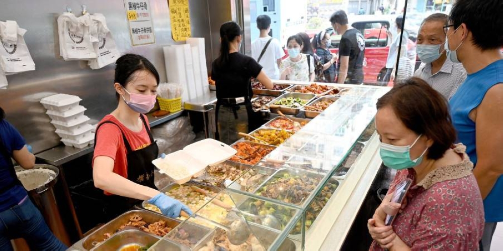 Customers being served low-priced two-dish mealboxes at Kitty Chan’s restaurant in Hong Kong. ― ETX Studio pic