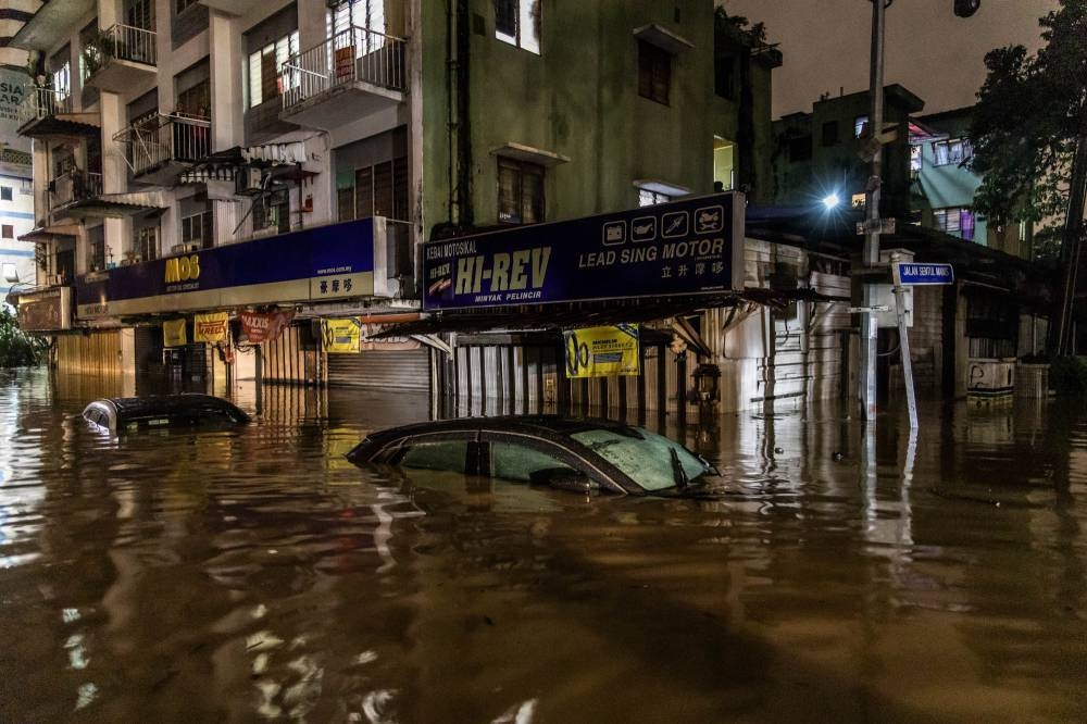 This December 2021 file photograph shows submerged cars on the flooded Jalan Sultan Azlan Shah in Kuala Lumpur. — Picture by Firdaus Latif