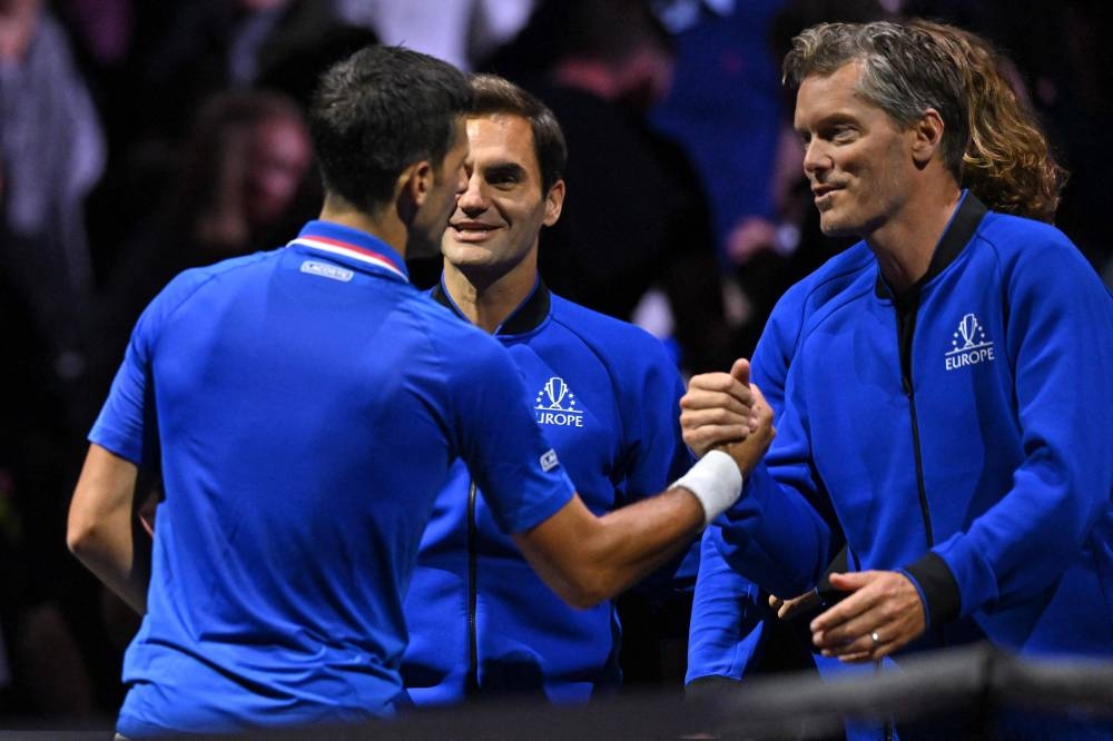 Novak Djokovic of Team Europe in congratulated by Roger Federer and Team Europe vice captain Thomas Enqvist after his win against Frances Tiafoe of Team World in their 2022 Laver Cup men's singles tennis match at the O2 Arena in London on September 24, 2022. — AFP pic