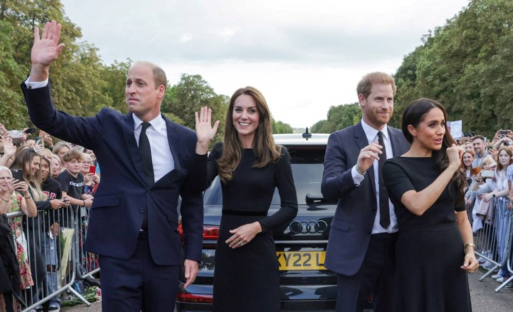 Britain’s William, Prince of Wales, Catherine, Princess of Wales, Britain’s Prince Harry and Meghan, the Duchess of Sussex, wave to members of the public at Windsor Castle, following the passing of Britain’s Queen Elizabeth, in Windsor, Britain, September 10, 2022. — Reuters pic